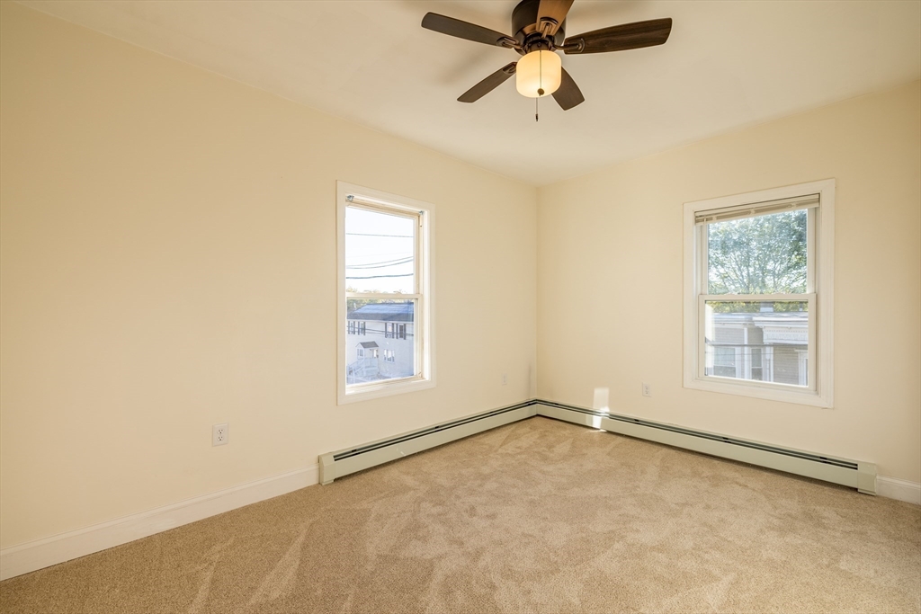 15 Rose Street, Unit 2 Haverhill, MA 01830 - Photo 8 of 15 an empty room with windows and fan