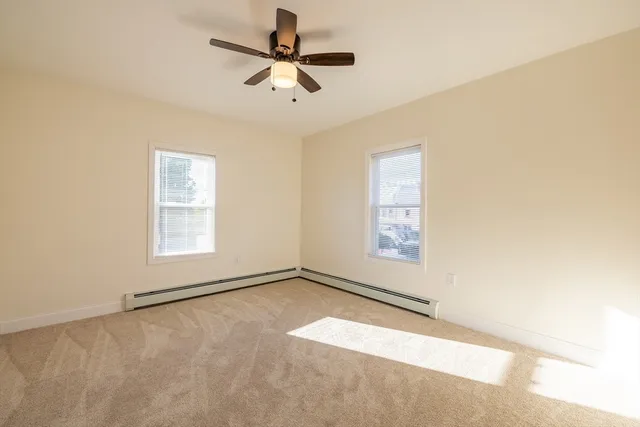 an empty room with a empty space and a ceiling fan