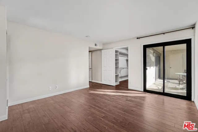 a bathroom with a granite countertop sink a toilet and a mirror