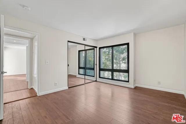 a bathroom with a granite countertop sink a toilet and a mirror