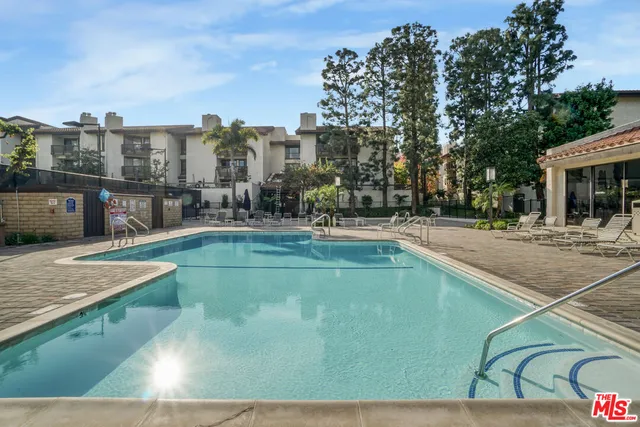 a living room with fireplace furniture and a large window