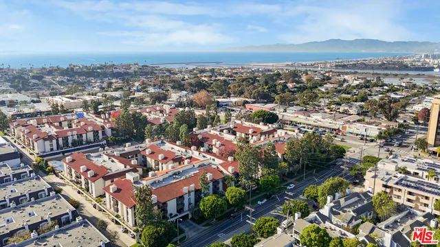 an aerial view of residential houses with city view