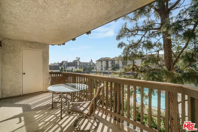 a balcony with table and chairs