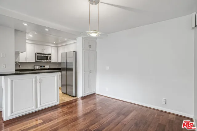 a kitchen with kitchen island a sink stove and refrigerator