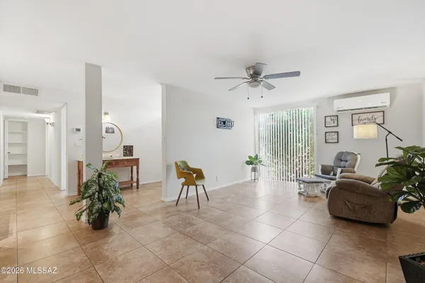 a living room with furniture and a potted plant