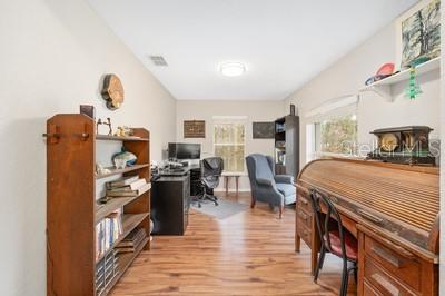 12351 Southwest 73rd Street Ocala, FL 34481 - Photo 12 of 77 a bedroom with furniture and a fireplace