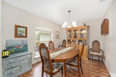 12351 Southwest 73rd Street Ocala, FL 34481 - Photo 14 of 77 a view of a dining room with furniture and chandelier