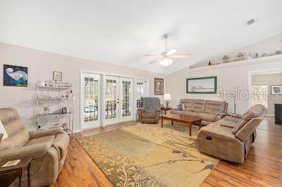 12351 Southwest 73rd Street Ocala, FL 34481 - Photo 19 of 77 a living room with furniture and a flat screen tv