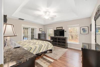 12351 Southwest 73rd Street Ocala, FL 34481 - Photo 20 of 77 a bedroom with a bed and flat screen tv