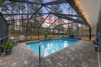 12351 Southwest 73rd Street Ocala, FL 34481 - Photo 2 of 77 a view of a swimming pool with a patio