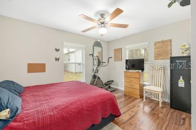 12351 Southwest 73rd Street Ocala, FL 34481 - Photo 26 of 77 a bedroom with a bed and a flat tv screen on dresser