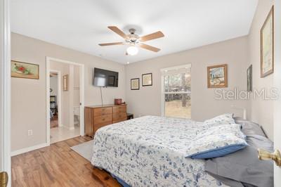 12351 Southwest 73rd Street Ocala, FL 34481 - Photo 29 of 77 a bedroom with a bed and a flat screen tv