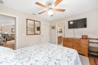 12351 Southwest 73rd Street Ocala, FL 34481 - Photo 30 of 77 a bedroom with a bed and a flat screen tv