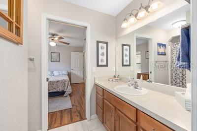 12351 Southwest 73rd Street Ocala, FL 34481 - Photo 33 of 77 a en suite bathroom with a sink double vanity and a mirror