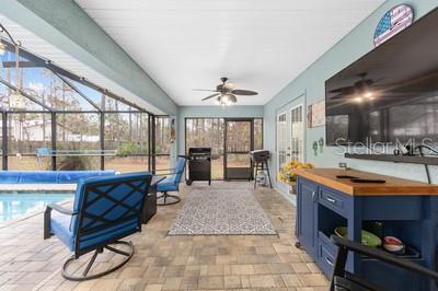 12351 Southwest 73rd Street Ocala, FL 34481 - Photo 43 of 77 a living room with stainless steel appliances kitchen island granite countertop furniture and a fireplace