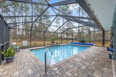 12351 Southwest 73rd Street Ocala, FL 34481 - Photo 46 of 77 a view of a swimming pool with a patio