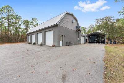 12351 Southwest 73rd Street Ocala, FL 34481 - Photo 70 of 77 a view of a house with a yard and garage
