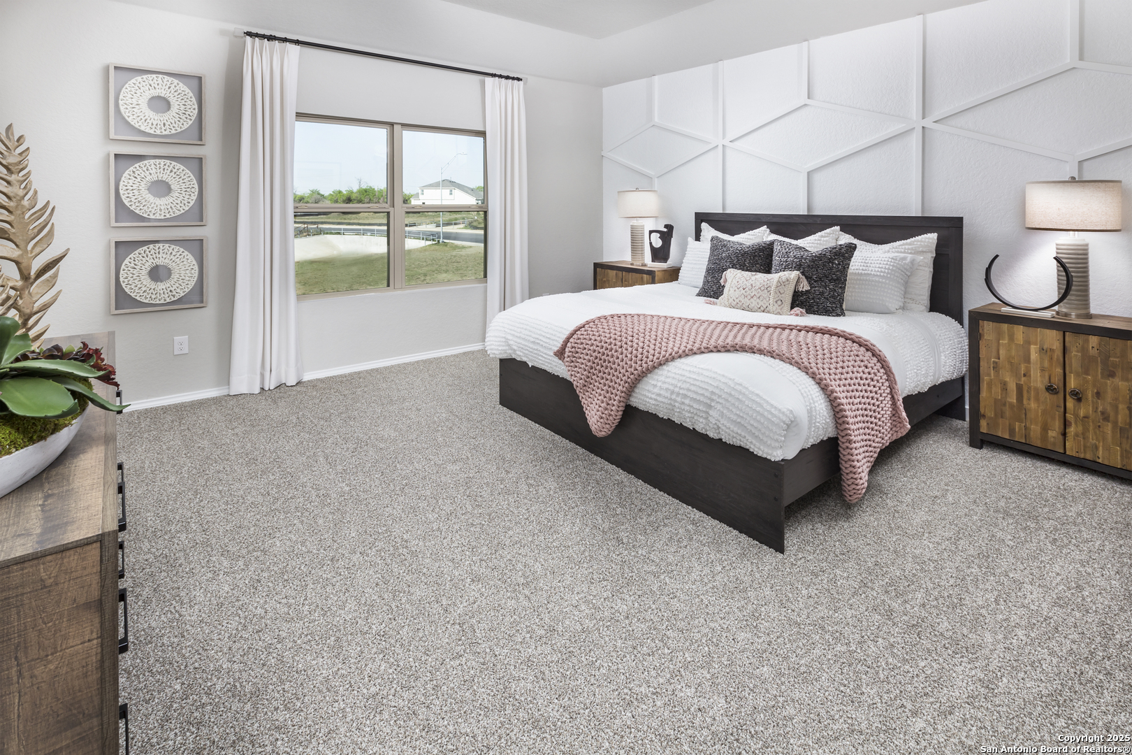 4907 Blue Ranch San Antonio, TX 78222 - Photo 8 of 18 a spacious bedroom with a bed a wall painting and a lamp