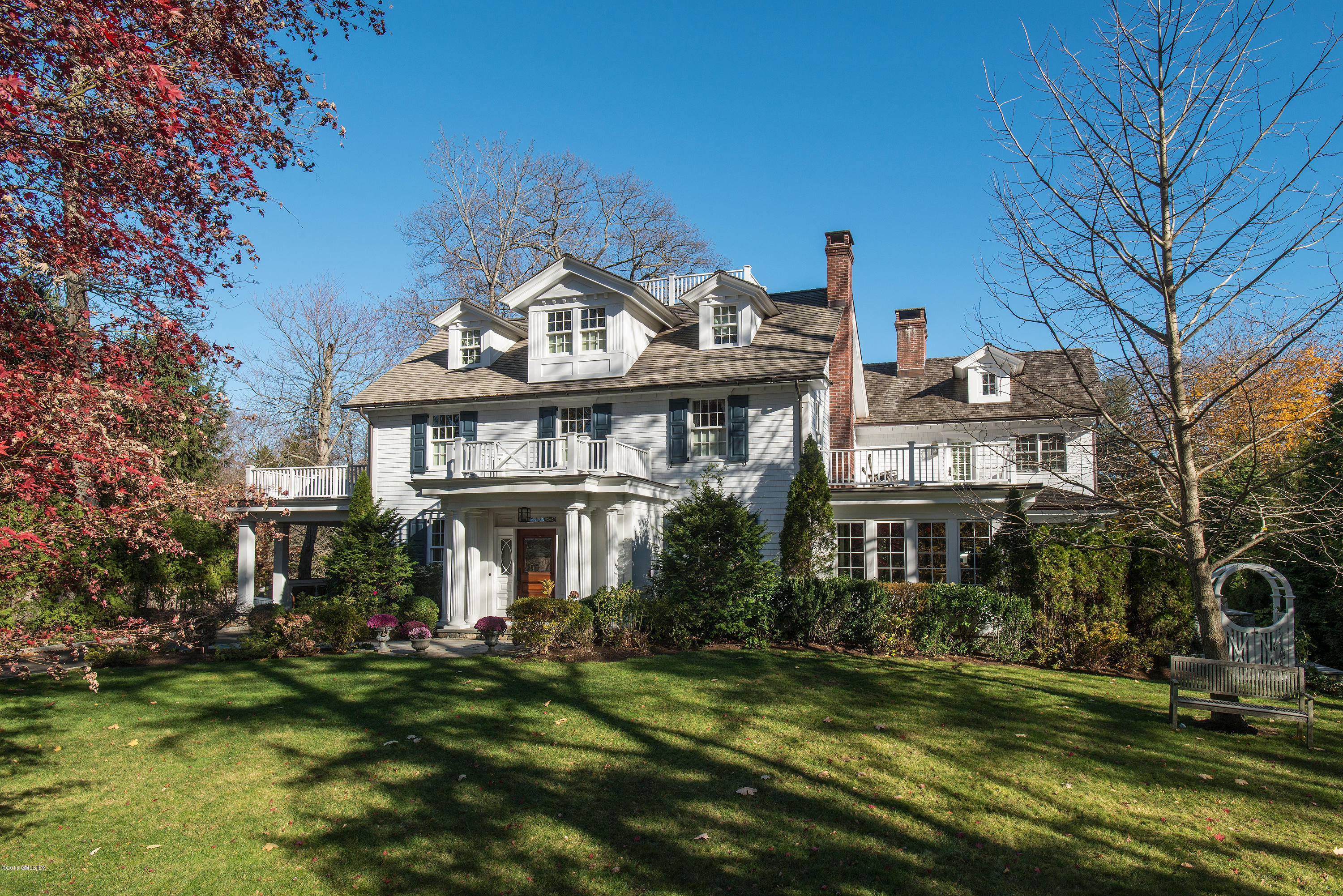 19 Indian Head Road Riverside, CT 06878 - Photo 1 of 34 a front view of a residential apartment building with a yard