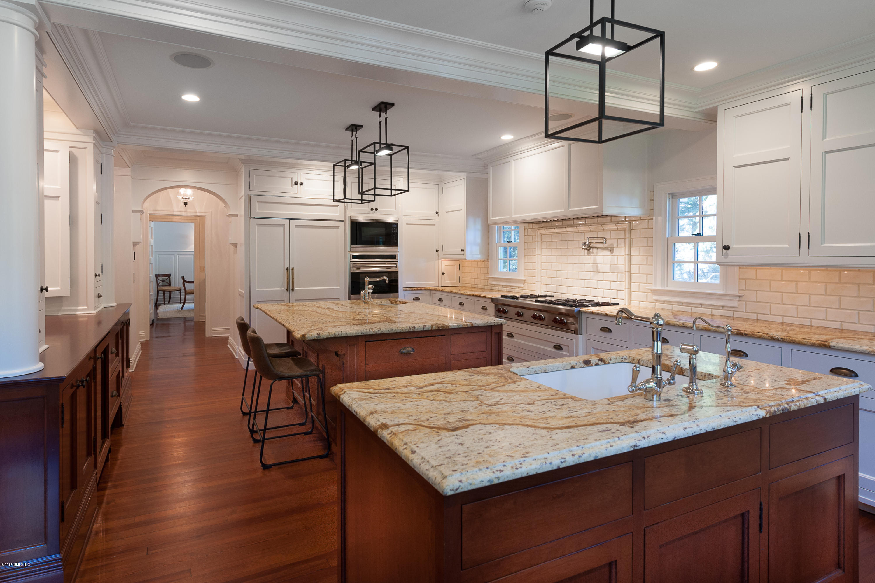 19 Indian Head Road Riverside, CT 06878 - Photo 12 of 34 a kitchen with granite countertop kitchen island stainless steel appliances a dining table and chairs