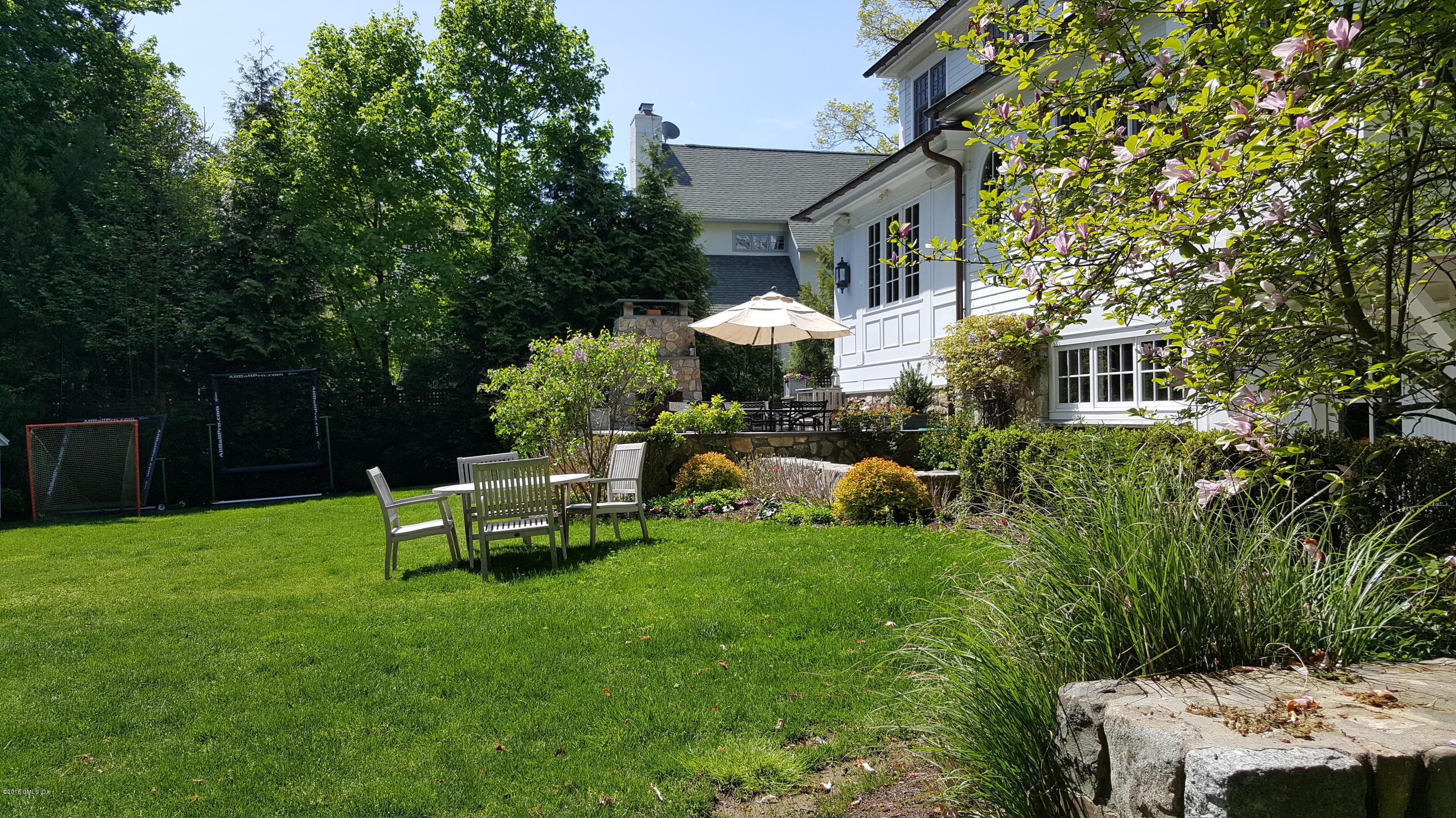 19 Indian Head Road Riverside, CT 06878 - Photo 20 of 34 a view of a house with backyard sitting area and garden