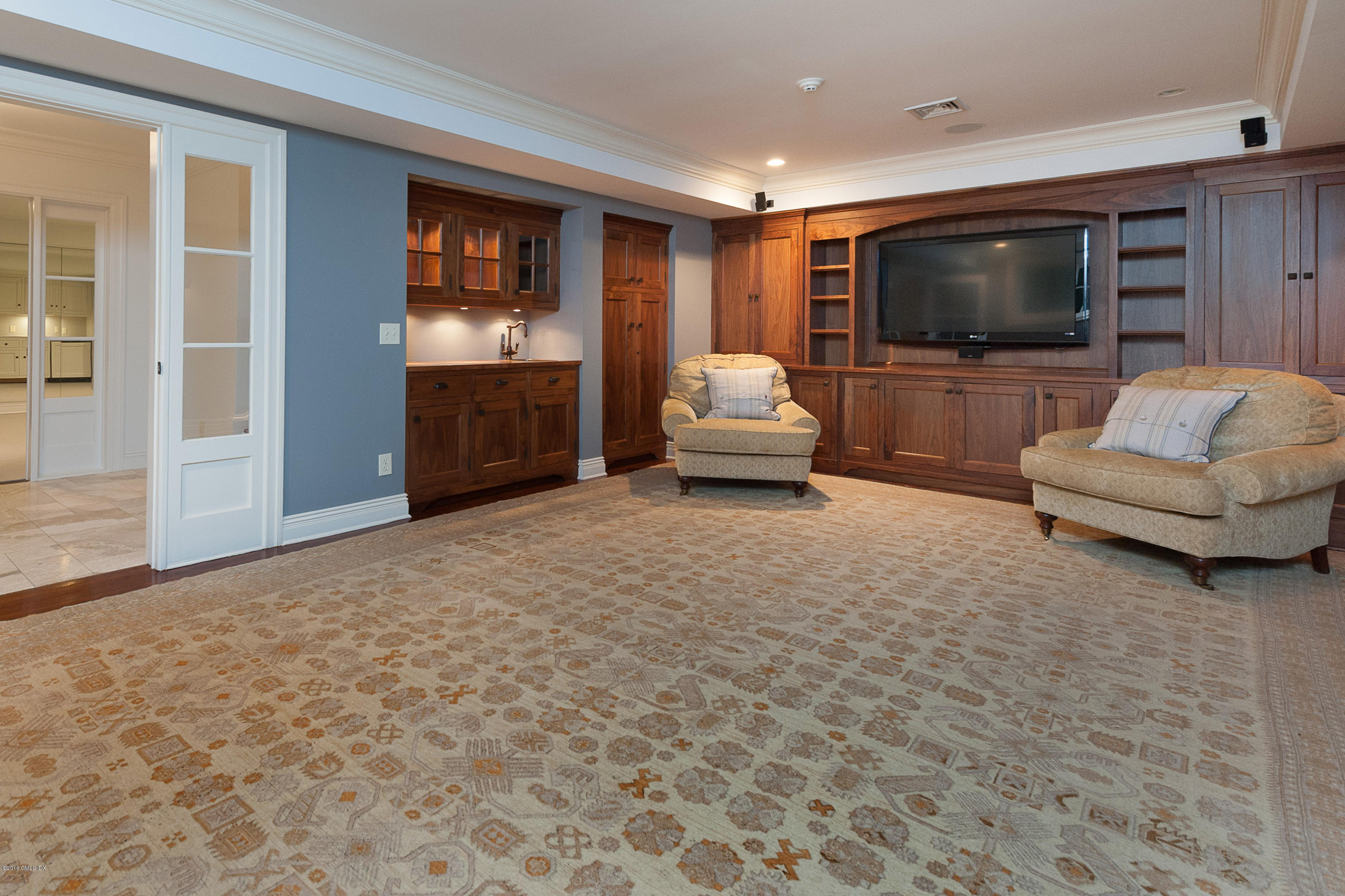 19 Indian Head Road Riverside, CT 06878 - Photo 21 of 34 a living room with furniture and a flat screen tv