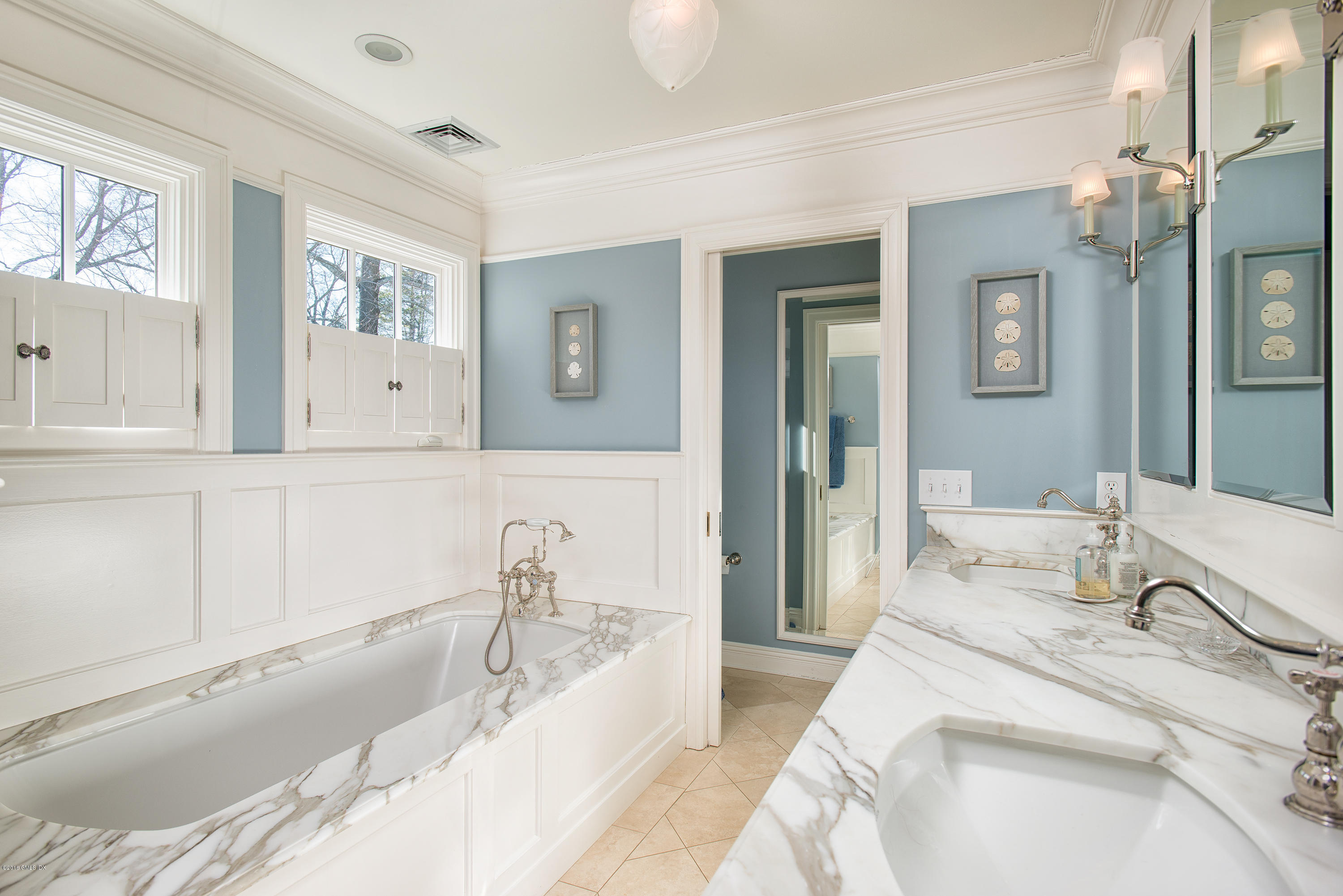 19 Indian Head Road Riverside, CT 06878 - Photo 24 of 34 a bathroom with a bathtub sink and mirror
