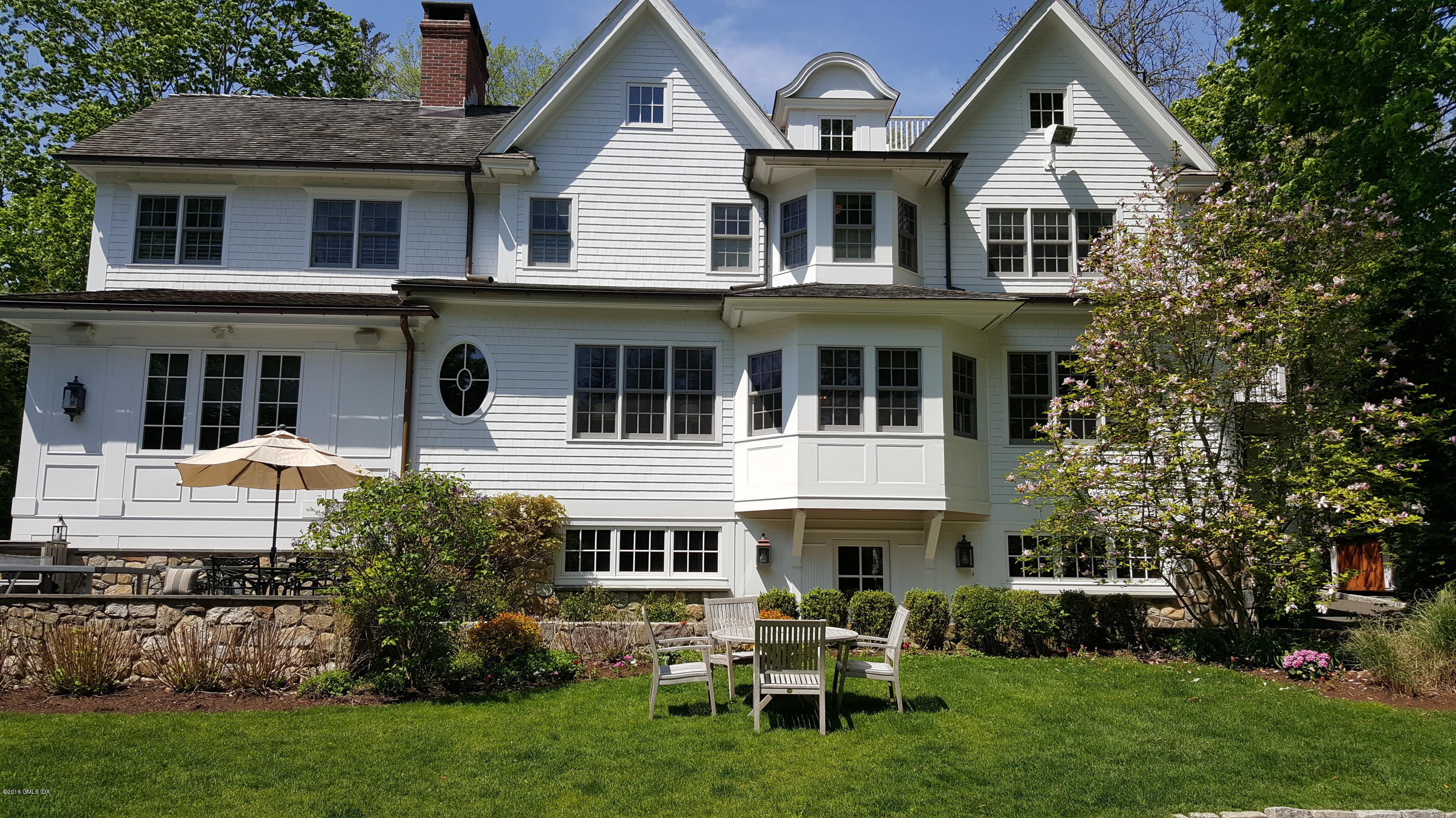 19 Indian Head Road Riverside, CT 06878 - Photo 30 of 34 a front view of a house with a garden and chairs