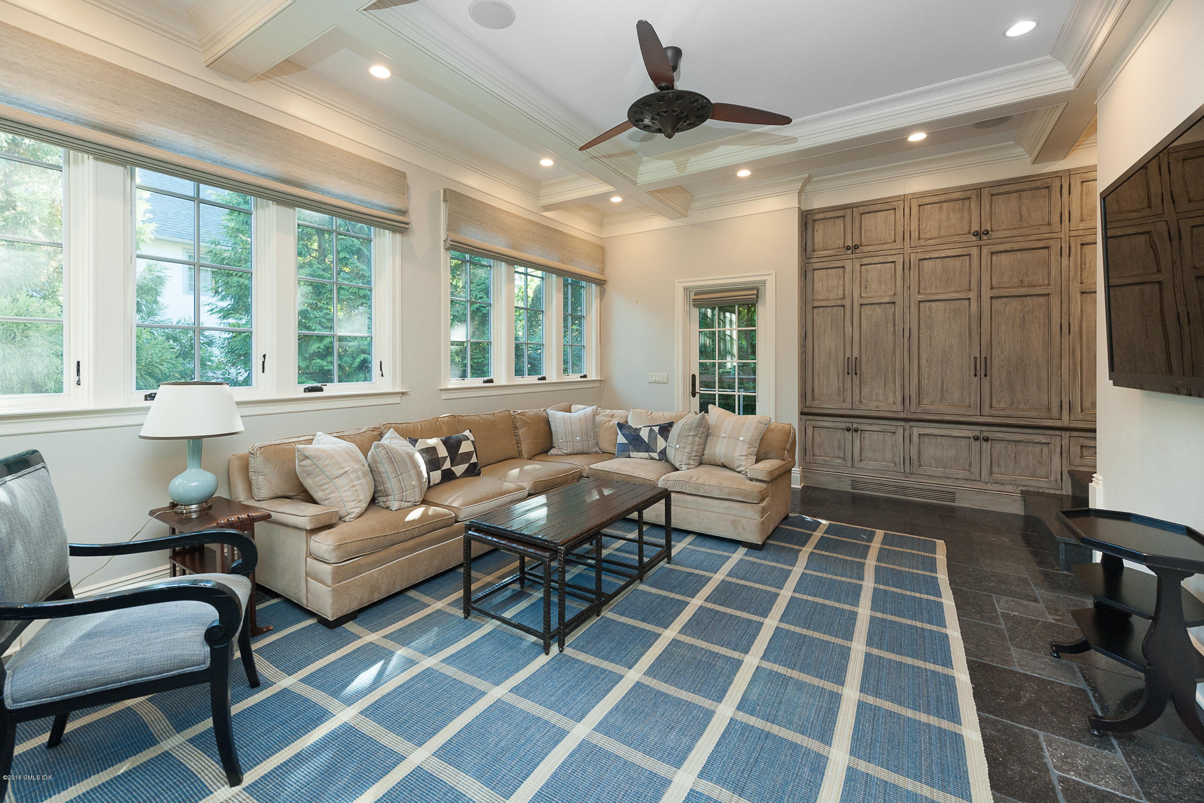 19 Indian Head Road Riverside, CT 06878 - Photo 10 of 34 a living room with a black white checkered floor with couches and a dining table with outer view