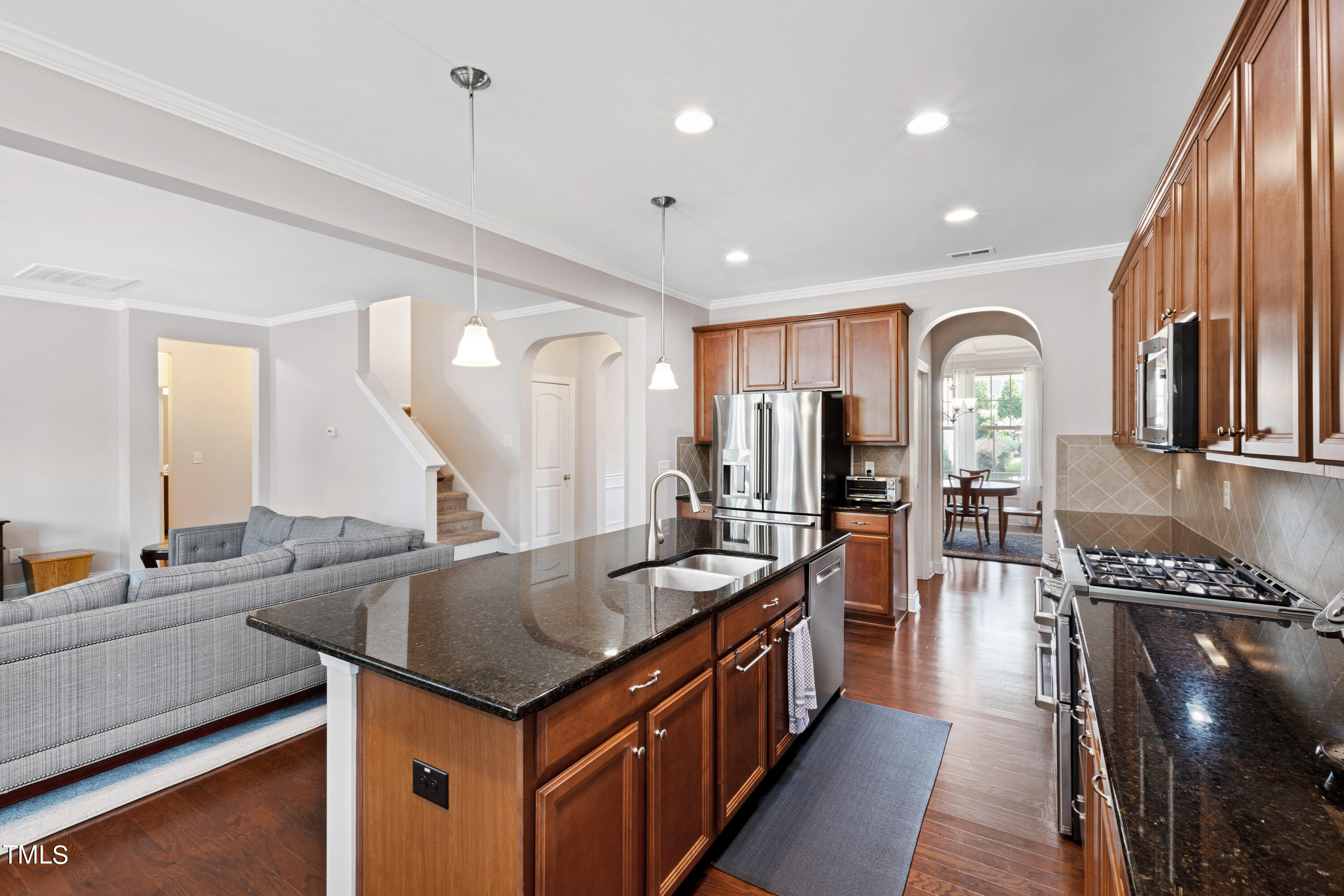 6004 Clapton Drive Wake Forest, NC 27587 - Photo 12 of 52 a kitchen with stainless steel appliances granite countertop a stove and a sink