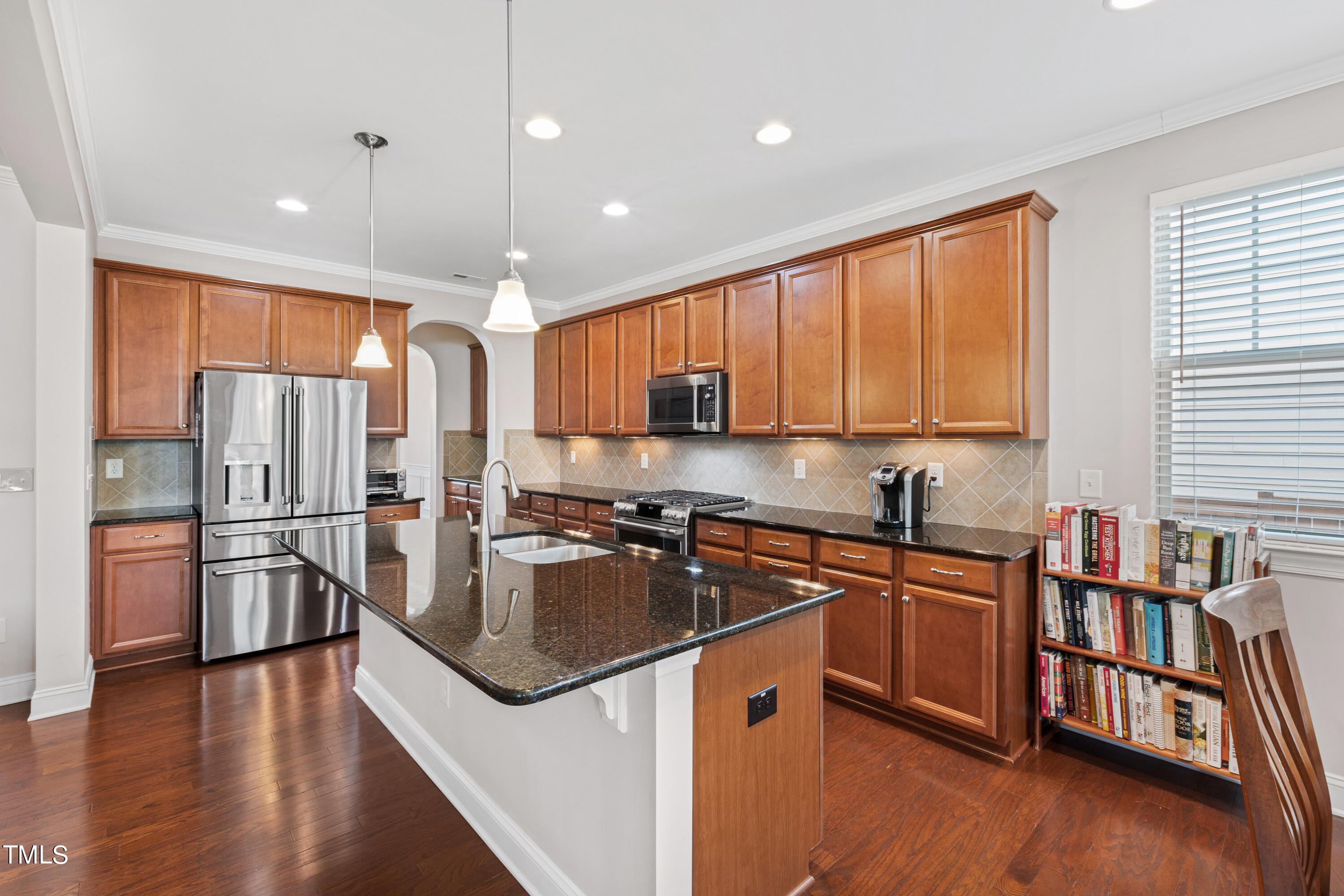 6004 Clapton Drive Wake Forest, NC 27587 - Photo 16 of 52 a kitchen with stainless steel appliances granite countertop a refrigerator a sink dishwasher a stove and white countertops with wooden floor