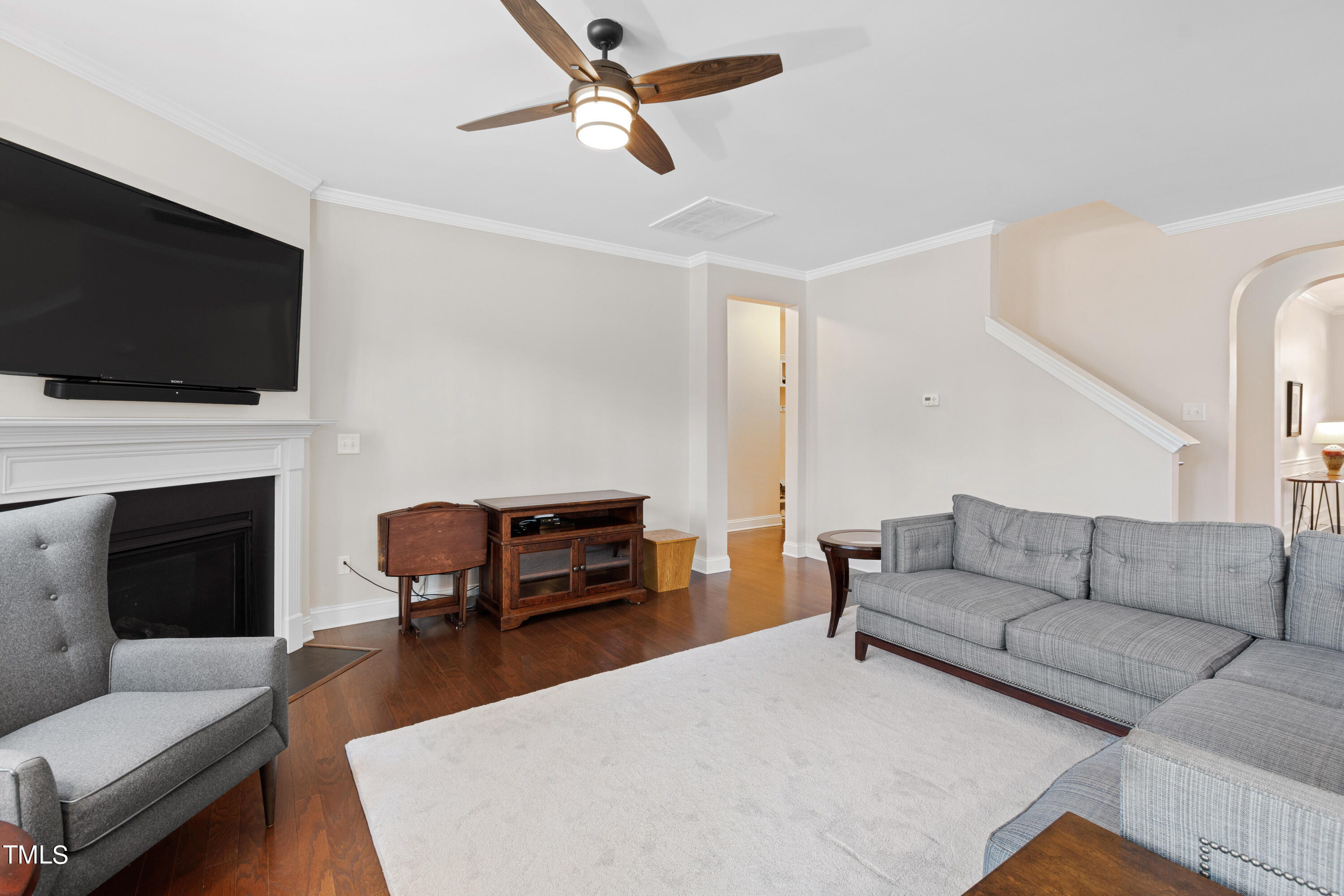 6004 Clapton Drive Wake Forest, NC 27587 - Photo 22 of 52 a living room with furniture a flat screen tv and a fireplace