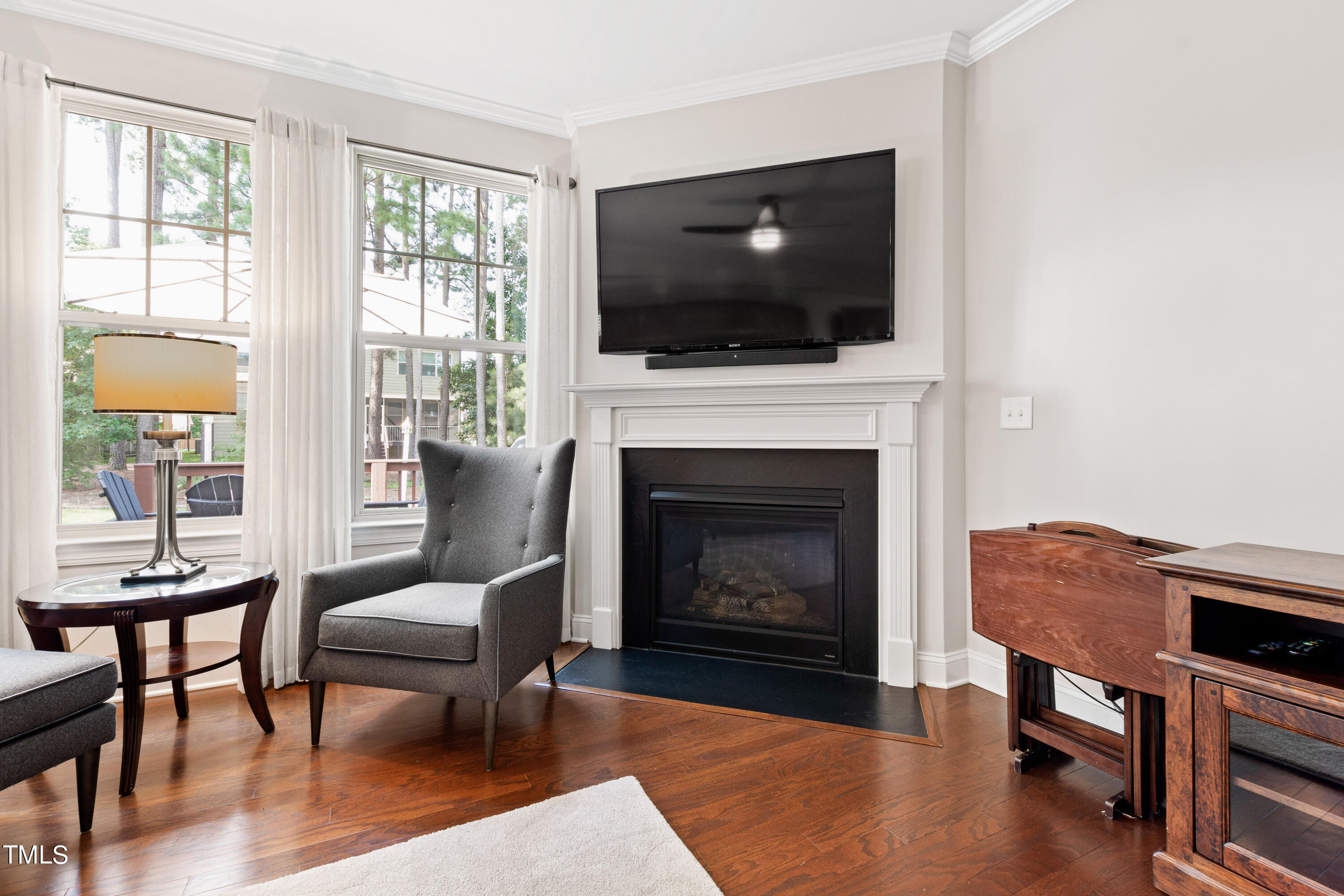 6004 Clapton Drive Wake Forest, NC 27587 - Photo 23 of 52 a living room with furniture a flat screen tv and a fireplace