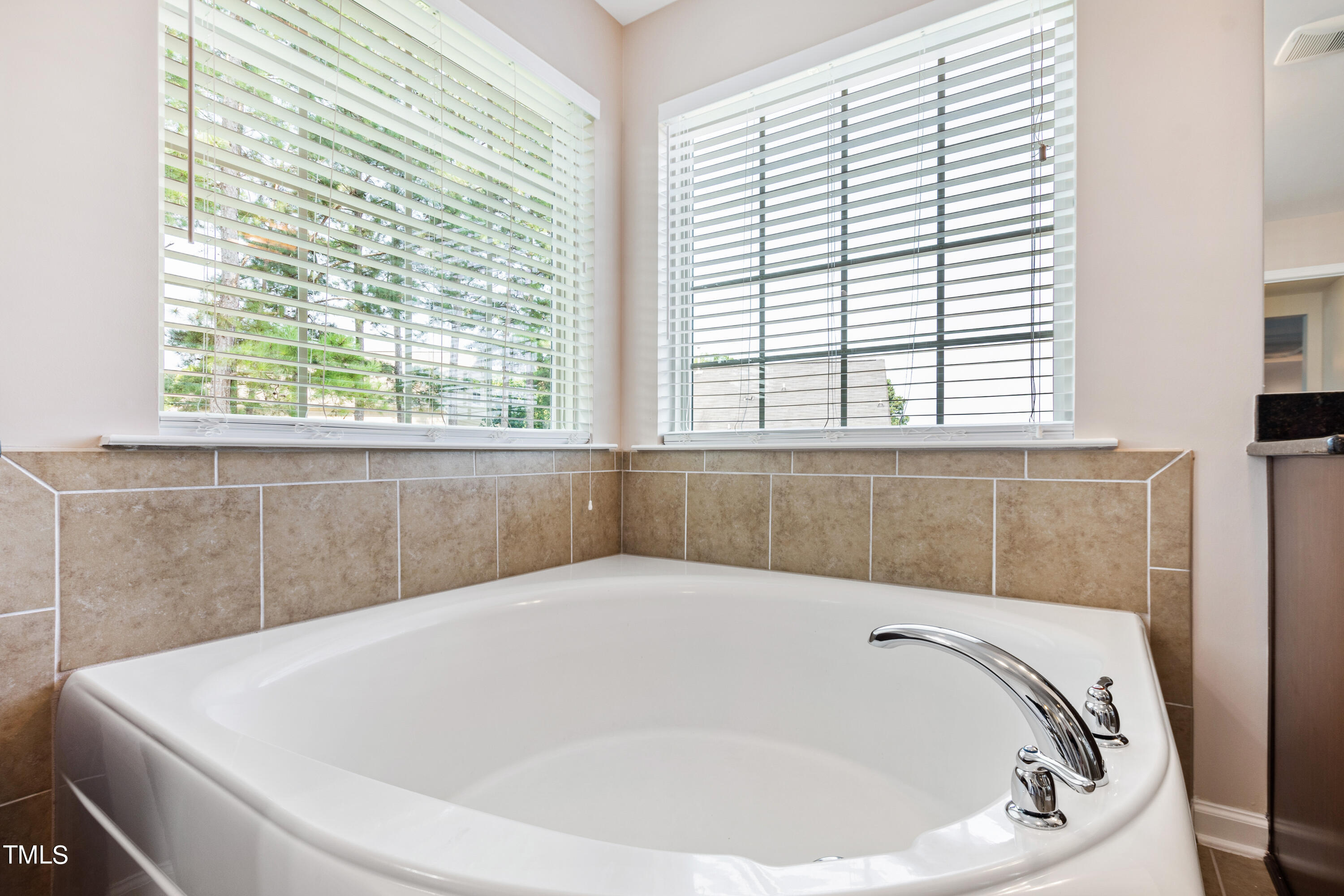 6004 Clapton Drive Wake Forest, NC 27587 - Photo 34 of 52 a white bath tub sitting in a bathroom next to a window