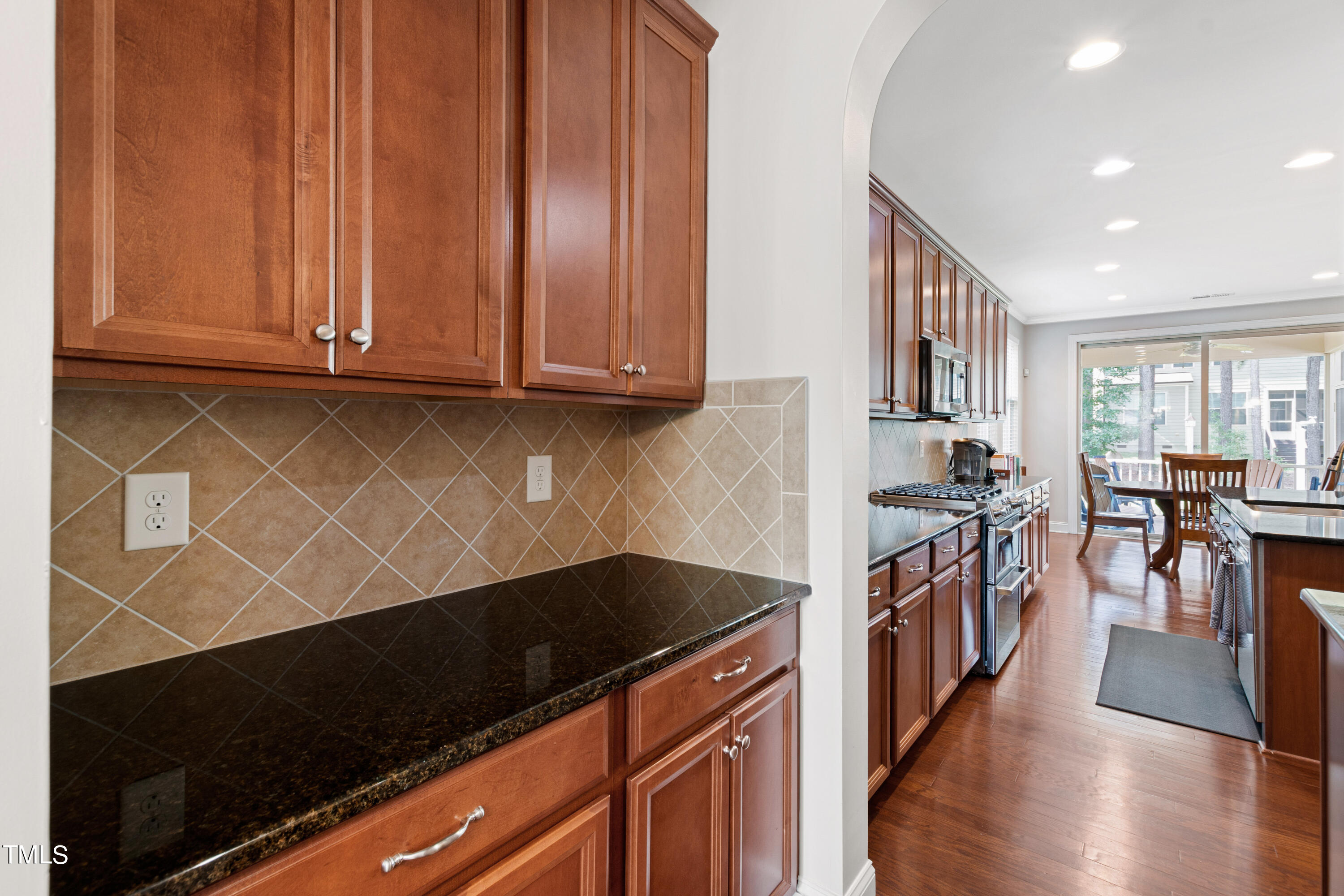6004 Clapton Drive Wake Forest, NC 27587 - Photo 10 of 52 a kitchen with granite countertop a stove and a wooden floors