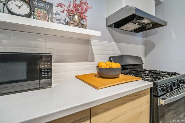 a stove top oven sitting inside of a kitchen