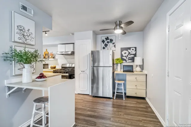 a kitchen with a refrigerator and microwave