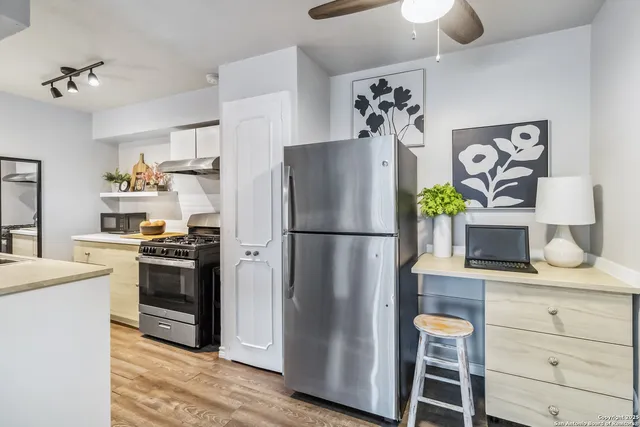 a kitchen with a refrigerator and a stove