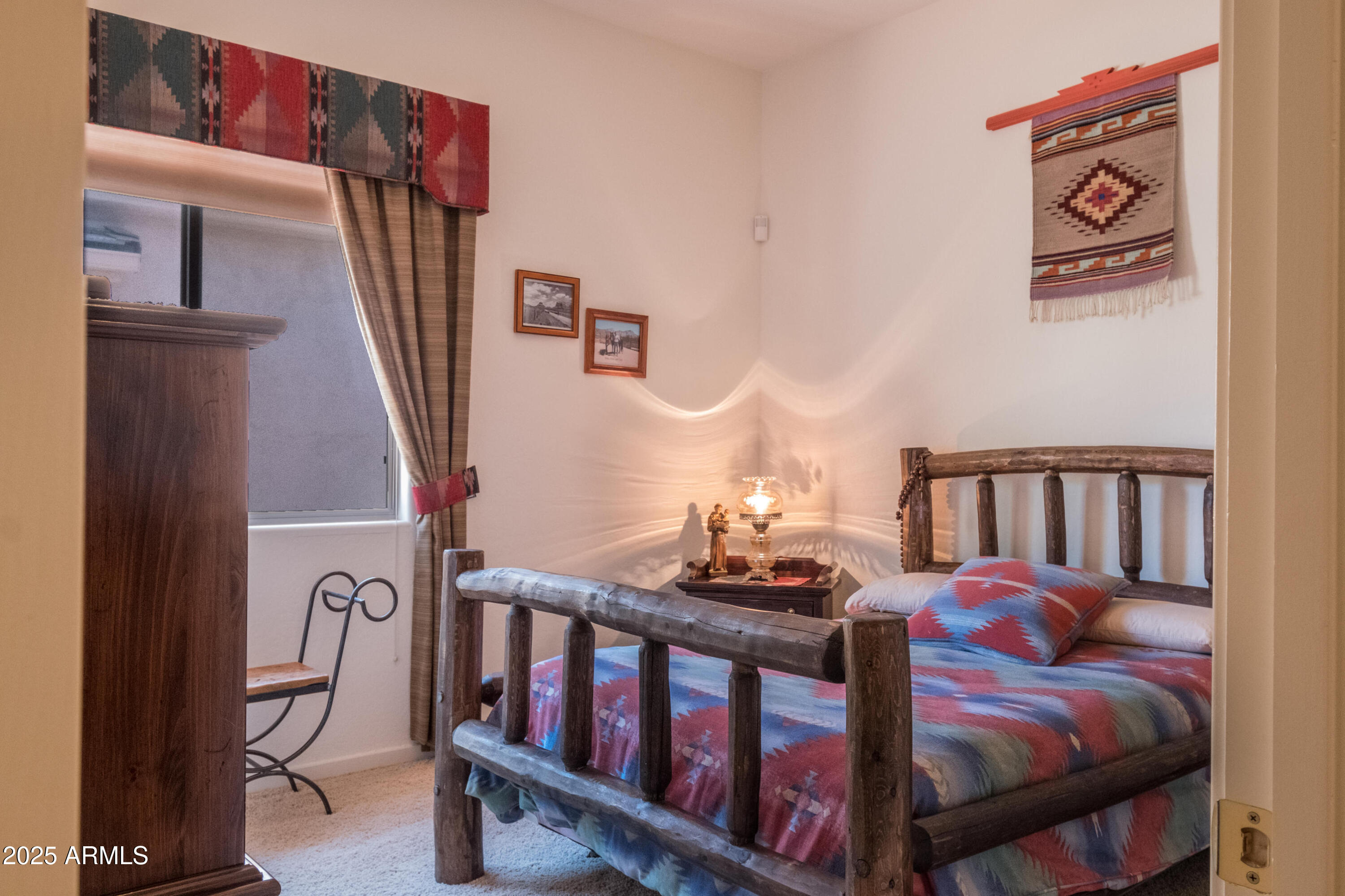 722 Crown Ridge Road Sedona, AZ 86351 - Photo 20 of 35 a bedroom with furniture and a window