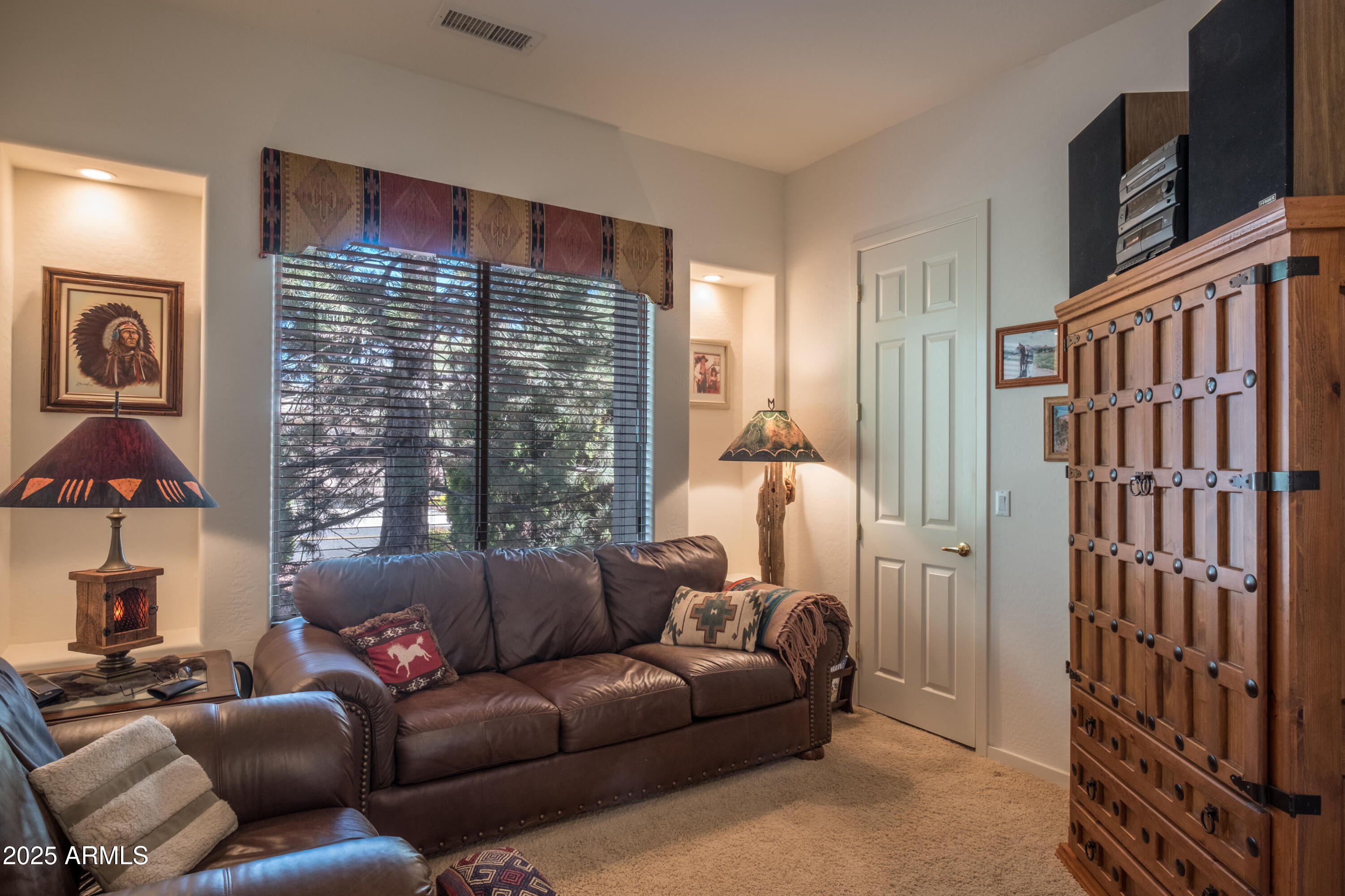 722 Crown Ridge Road Sedona, AZ 86351 - Photo 22 of 35 a living room with furniture a lamp and a flat screen tv