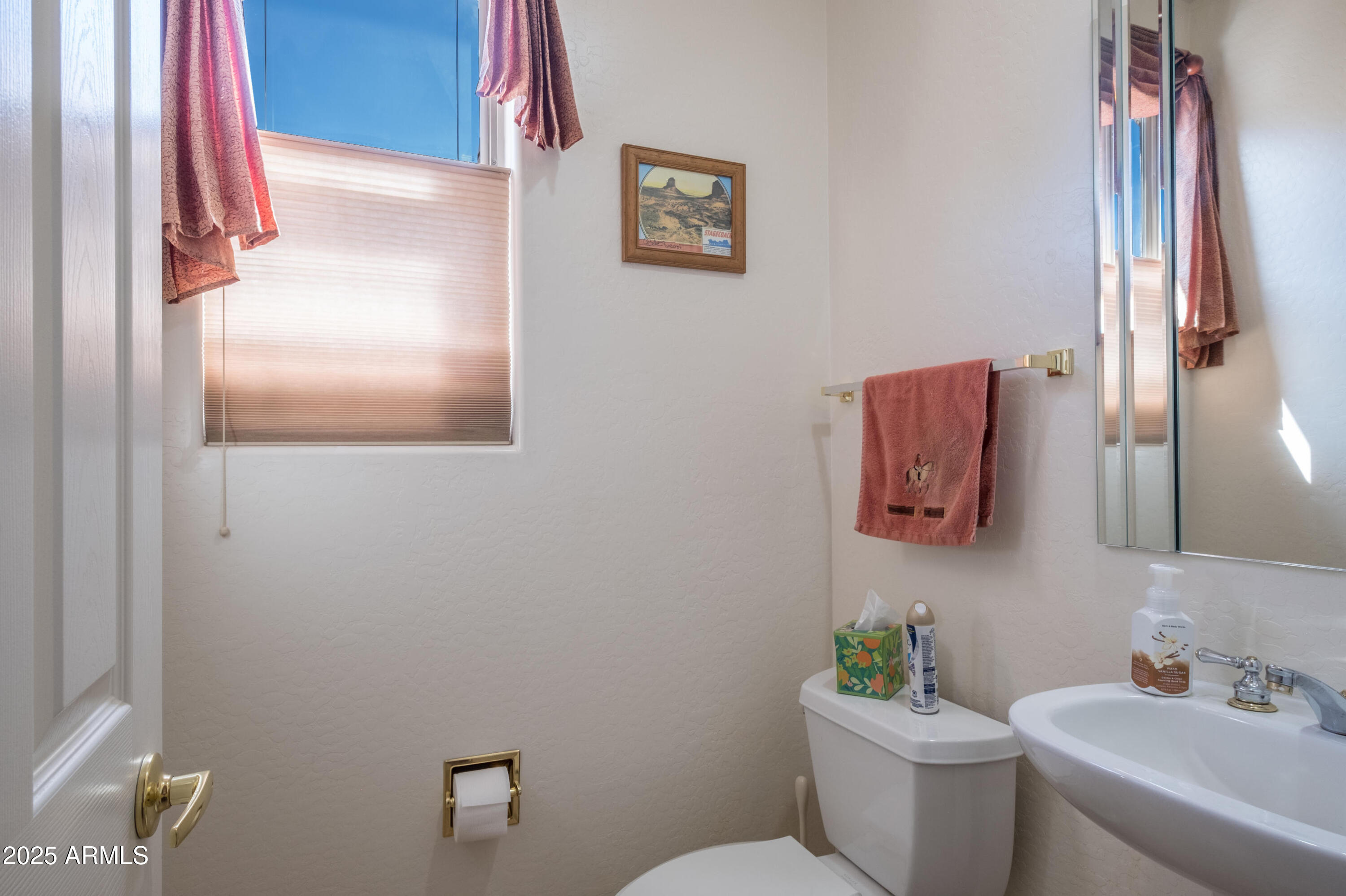 722 Crown Ridge Road Sedona, AZ 86351 - Photo 25 of 35 a bathroom with a toilet sink and mirror