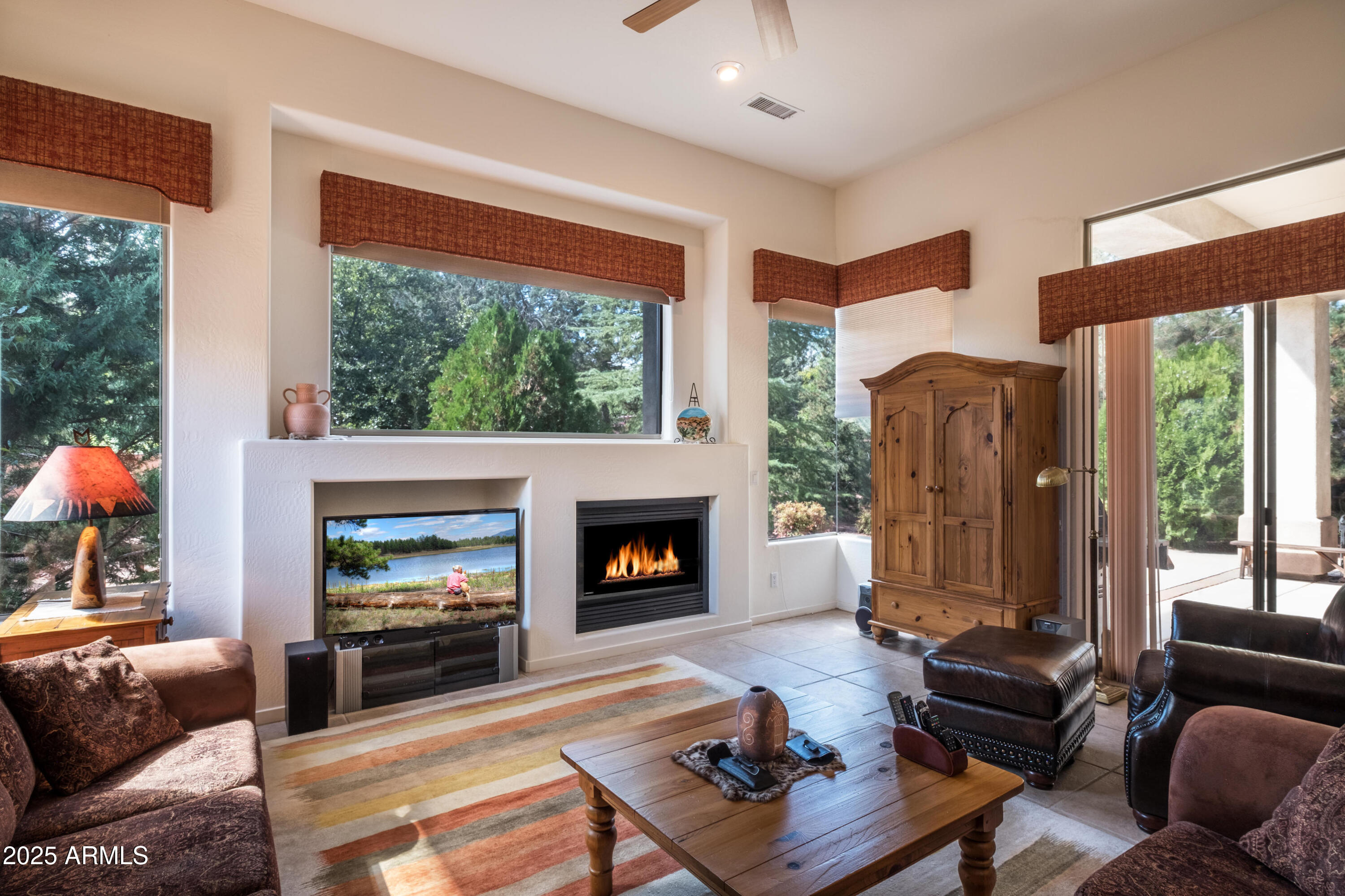 722 Crown Ridge Road Sedona, AZ 86351 - Photo 5 of 35 a living room with furniture fireplace and a large window