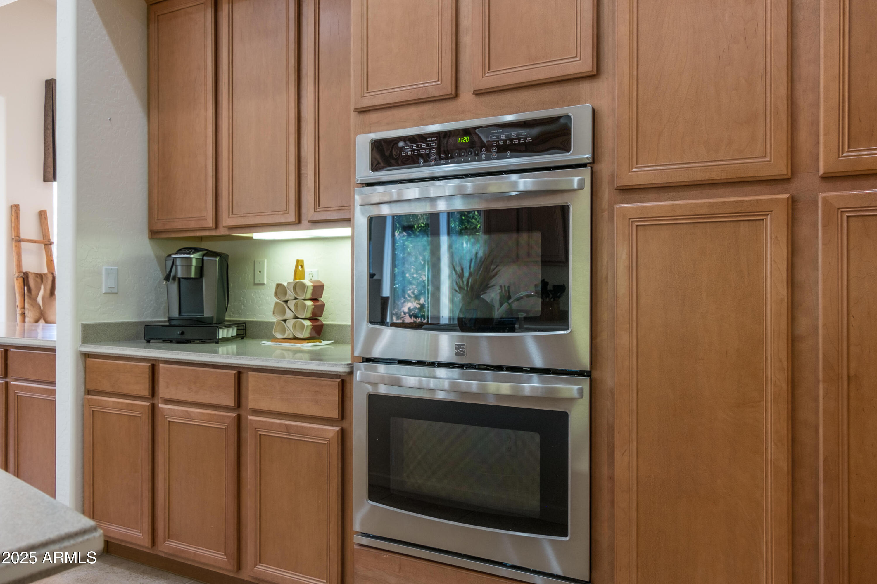 722 Crown Ridge Road Sedona, AZ 86351 - Photo 9 of 35 a kitchen with granite countertop white cabinets and stainless steel appliances