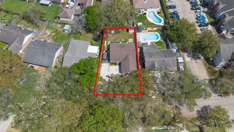 an aerial view of house with yard and swimming pool