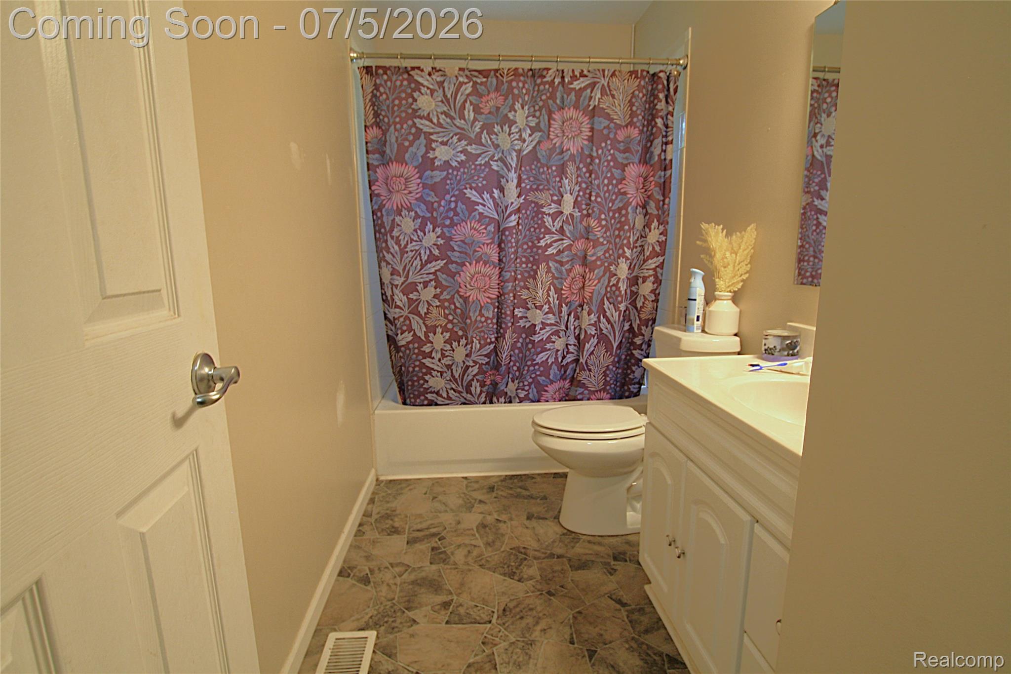 12403 Willard Road Montrose, MI 48457 - Photo 25 of 30 Full bathroom with a white vanity featuring cabinet storage, a white countertop, and an integrated sink