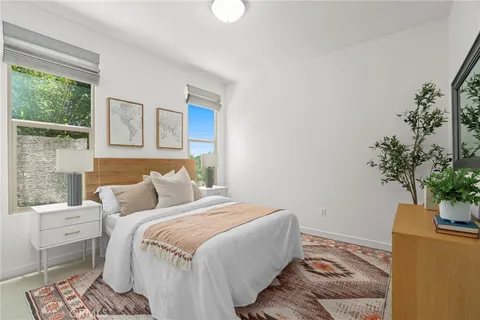 a bedroom with a bed and a potted plant
