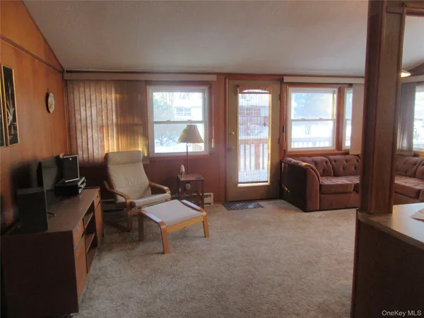 a living room with furniture and large windows