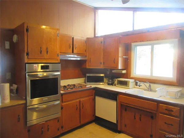 a kitchen with a sink stove and cabinets
