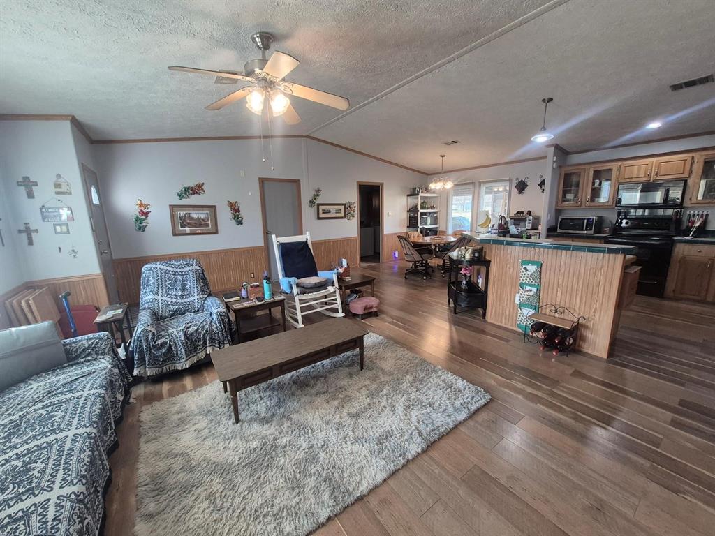 438 Silver River Road Gholson, TX 76705 - Photo 25 of 39 a living room with furniture and a wooden floor
