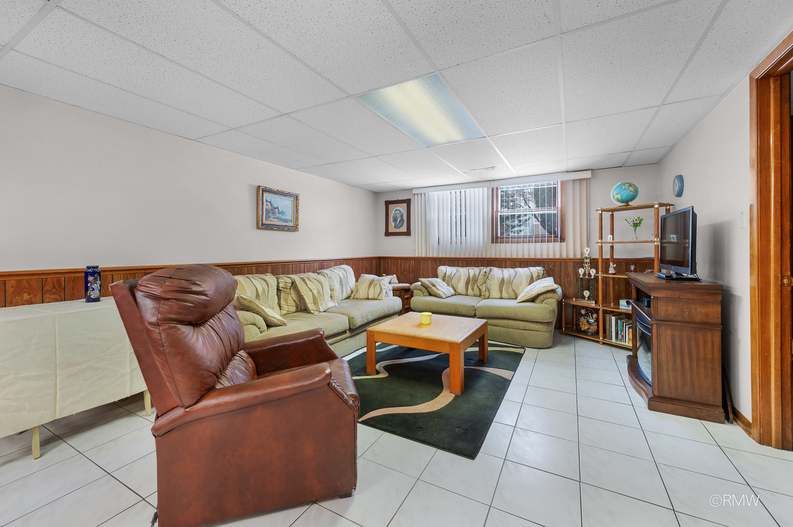 1306 West Byron Avenue Addison, IL 60101 - Photo 12 of 25 a living room with furniture and a flat screen tv